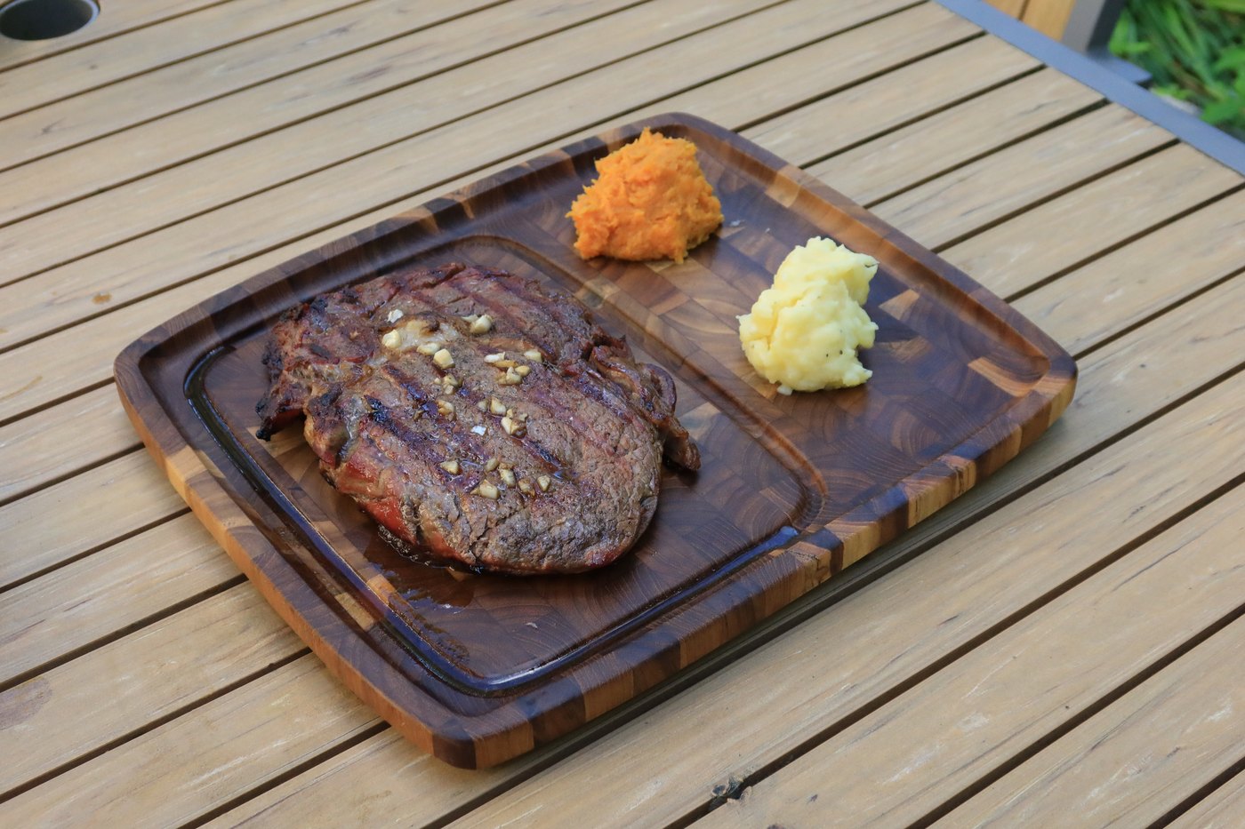 Divided side zone holding mashed and sweet potato beside a steak