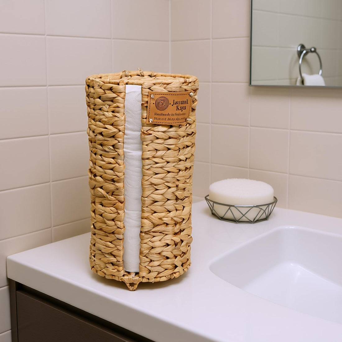 Water hyacinth toilet paper holder styled on a bathroom vanity counter
