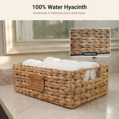 Small water hyacinth basket holding rolled towels, with a close-up of the weave