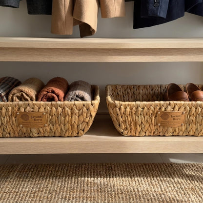 Pair of woven trays on a wardrobe shelf holding folded knitwear and shoes