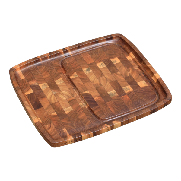 Solid teak end-grain steak plate with juice groove, divided zone, and engraved Javanti Kayu logo