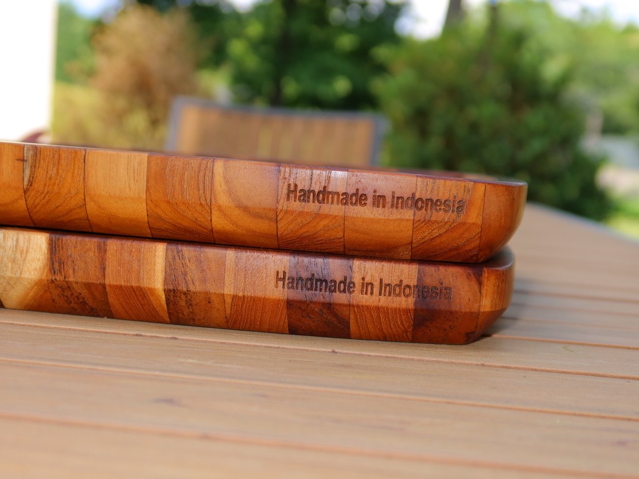 Two stacked teak steak plates engraved Handmade in Indonesia